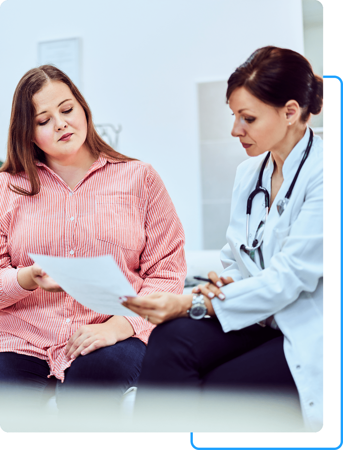 Group 60 A woman sitting next to a doctor holding papers.